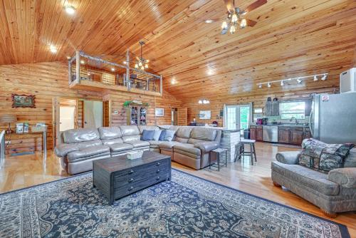 a large living room with couches and a kitchen at Woodsy Kentucky Escape with Game Room and Lake Access! in Burnside