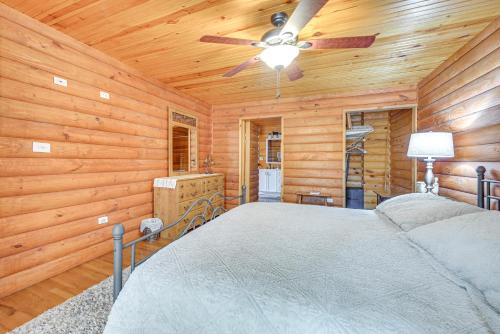 a bedroom with a bed and a ceiling fan at Woodsy Kentucky Escape with Game Room and Lake Access! in Burnside