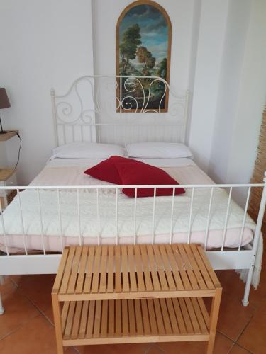a bedroom with a white bed and a wooden bench at Casa Vacanza Cascina Ronco relax nella natura vicino a Como e Bellagio in Erba