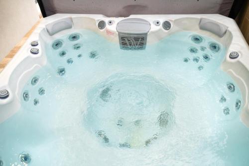 a jacuzzi tub with a sink in it at REMZ Apartments & Wellness in Dorog