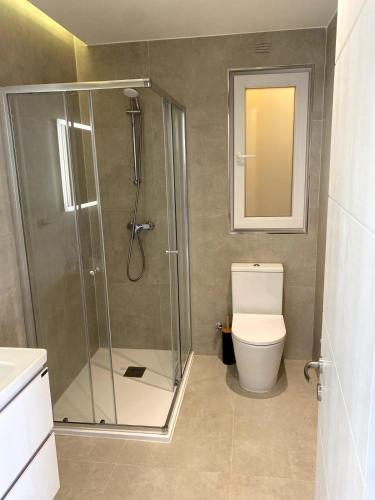 a bathroom with a shower and a toilet at The Valley Collection - Suite A21 in Xagħra
