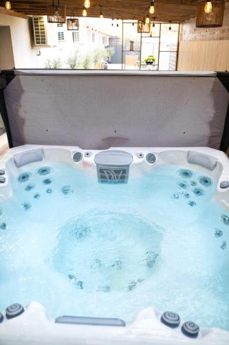 a jacuzzi tub with a shopping cart in it at REMZ Apartments & Wellness in Dorog