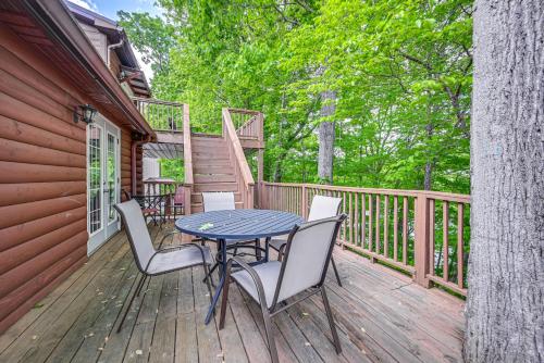 a patio with a table and chairs on a deck at Woodsy Kentucky Escape with Game Room and Lake Access! in Burnside