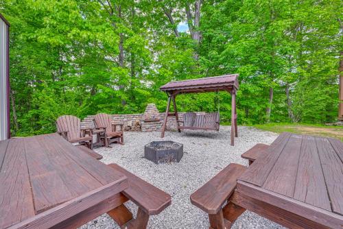 two wooden picnic tables and a fire pit in a yard at Woodsy Kentucky Escape with Game Room and Lake Access! in Burnside