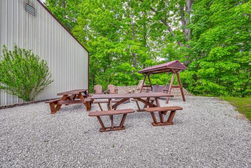 two benches and a picnic table with a gazebo at Woodsy Kentucky Escape with Game Room and Lake Access! in Burnside