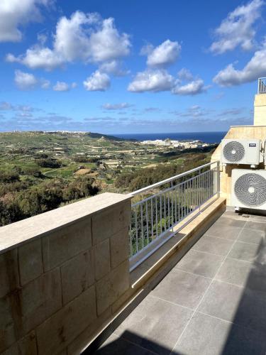 a balcony with a view of the ocean at The Valley Collection - Suite A21 in Xagħra