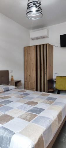 a bedroom with a large bed in a room at B&b S'Erbei Niedda Guesthouse in Seùlo