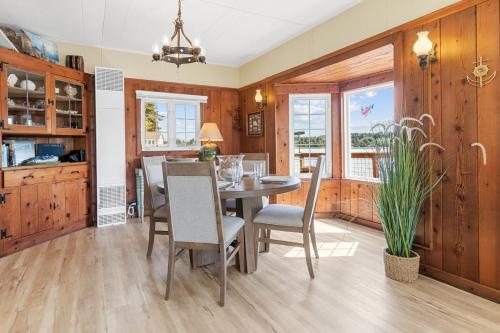 a dining room with a table and chairs at Charming Beach Cabin in Quartermaster Harbor in Vashon