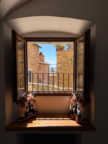 an open window with a view of a balcony at Bilocale vista mare nel borgo di Campiglia Marittima in Campiglia Marittima