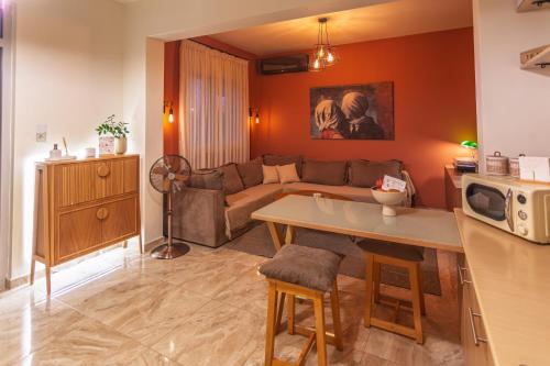 a living room with a couch and a table at Ledeza Apartment Igoumenitsa in Ladochórion