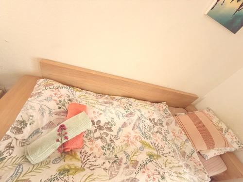 a bed with a pillow with a book on it at Villa le Castellet et proche circuit Paul-Ricard à 20 mn de la Mer in Signes