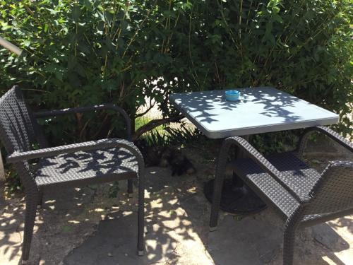 two chairs and a table with a cup on top at Chez Catherine in Vorey