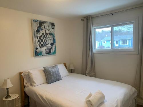 a bedroom with a white bed in front of a window at 2 bedrooms house in Coldbrooke in Coldbrook