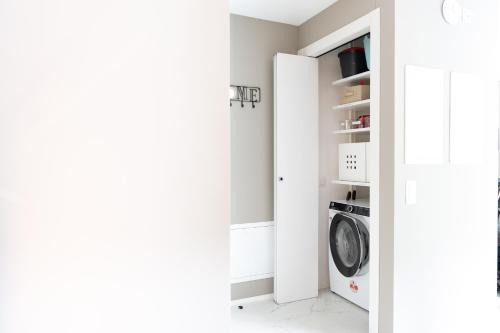 a white laundry room with a washer and dryer at Locarno Center - Free Parking, Netflix and WiFi in Locarno
