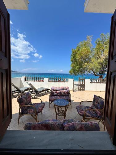 a view of a patio with chairs and a table at Sea View in Kámpos