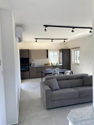 a living room with a couch and a table at The Valley Collection - A25 - with Private hot tub in Xagħra