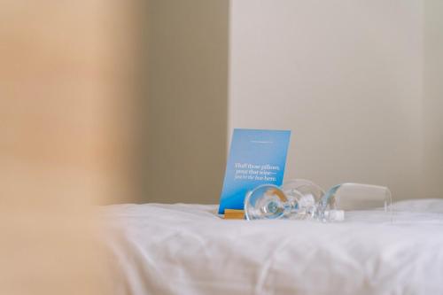 a blue book sitting on top of a bed at The Valley Collection - A25 - with Private hot tub in Xagħra