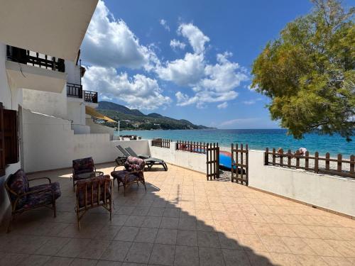 a patio with chairs and a view of the ocean at Sea View in Kámpos