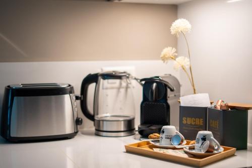 a kitchen counter with a coffee maker and a coffee pot at Locarno Center - Free Parking, Netflix and WiFi in Locarno
