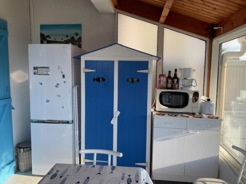 La cuisine est équipée d'un réfrigérateur bleu et d'un four micro-ondes. dans l'établissement Entre mer et centre-ville, à La Tranche-sur-Mer