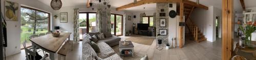 a living room with a couch and a table at Lavender Cottage in Sucha Rzeczka