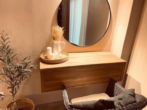 a bathroom with a mirror and a chair and a chair sidx sidx sidx at KIPOS-SS residences in Dassia