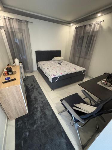 a bedroom with a bed and a table and chairs at Ferienhaus Rovine in Ivišovo Greblje