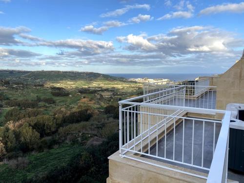 a balcony of a house with a view at The Valley Collection - B26 - with Private hot tub in Xagħra