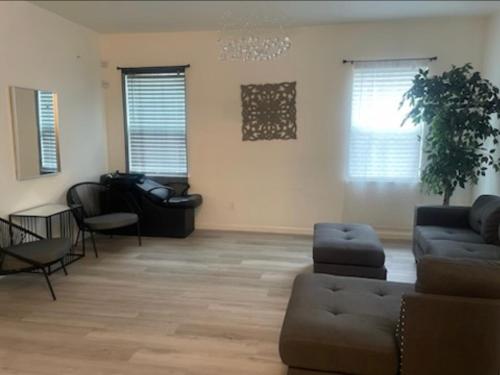 a living room with a couch and a chair at Spacious 4 bedroom house! in Stockton