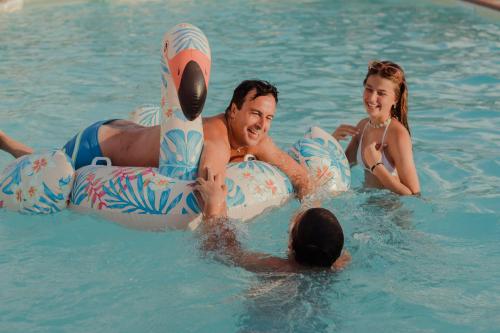 a group of people in the water in a pool at Agriturismo Podere L'Agave in San Vincenzo