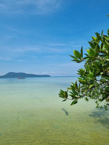 a view of the water with a boat in the distance at Mangrove Beach Bungalows in Koh Rong Sanloem