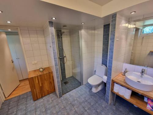 a bathroom with a toilet and a shower and a sink at Bed Breakfast in Stockholm in Stockholm