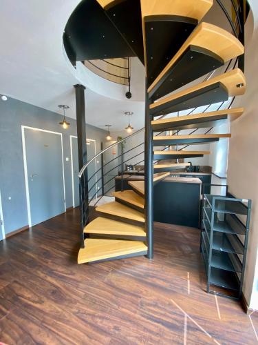 a spiral staircase in a house with wooden floors at Ferienhaus Dudeldorf in Dudeldorf