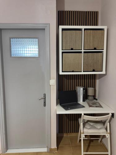 a room with a desk with a laptop and a window at Koroni Dream House in Koroni
