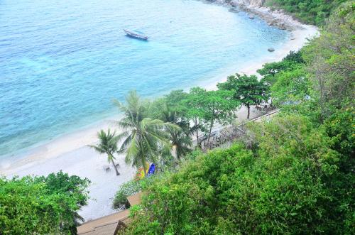 a view of a beach with a boat in the water at Sai Daeng Resort in Koh Tao