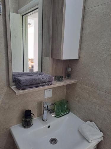 a bathroom with a sink and a mirror at Relax House in Vrančići