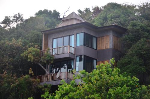 a house on top of a hill with trees at Sai Daeng Resort in Koh Tao