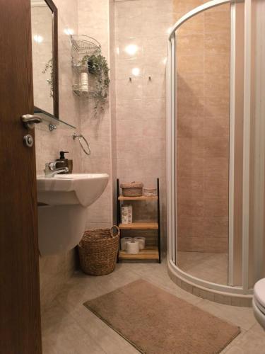 a bathroom with a shower and a sink and a toilet at Lavender Apartment in Sozopol