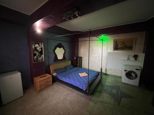 a bedroom with a bed with a blue comforter at Răsfăț cazare in Focşani