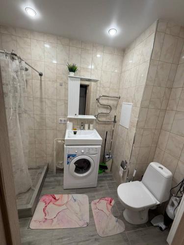 a bathroom with a washing machine and a toilet at Family house near the beach 24 in Male City