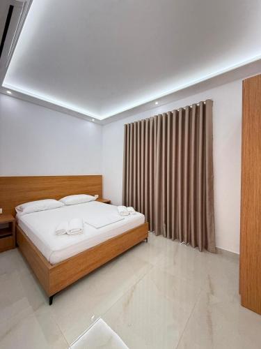 a bedroom with a large bed and a window at Villa Papa-Berat in Berat