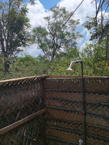 a street light next to a wooden fence at Block 5 Safari Camp - Yala National Park in Kohombagahapelessa