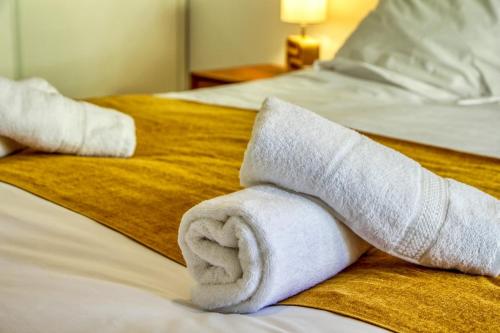 a pile of rolled up towels on a bed at - Le Maréchal- Port de Vannes in Vannes