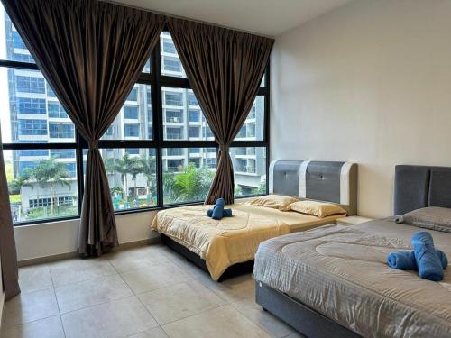 a bedroom with two beds and a large window at Atlantis Residence Melaka by HK 2 BR in Tranquerah