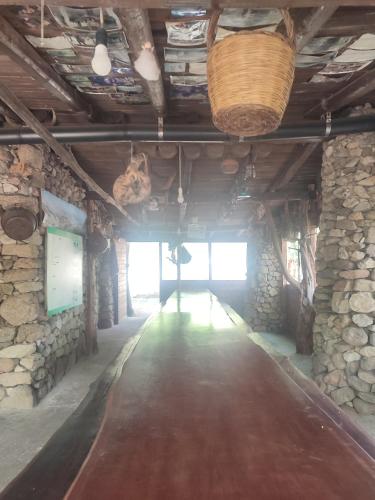 a long hallway in a building with stone walls at Appartamento Meduse in Cala Gonone