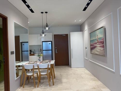 a kitchen and dining room with a table and chairs at Sky Suites City Centre in Kuala Lumpur