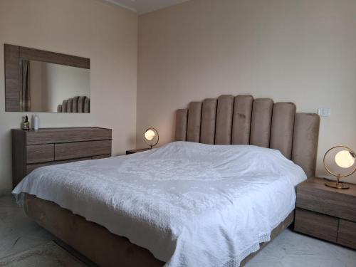 a bedroom with a large bed with two night stands and two lamps at Luxurious apartment Jardin Carthage - 2 bedrooms in Sidi Daoud