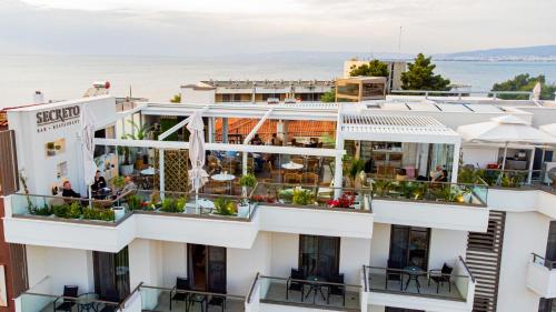 a view of a building with tables and chairs at Sky Boutique Hotel in Perea