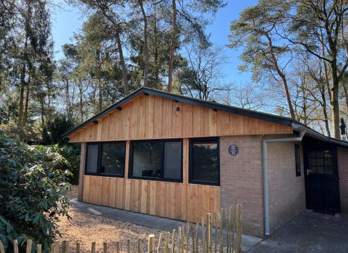 a small building with a brick at Forest Bungalow 1 - Hottub - Nature - Relax in Rheezerveen