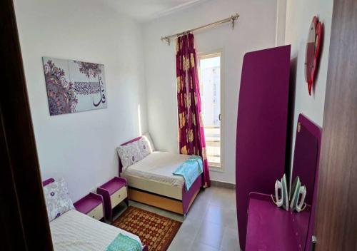 a small room with two beds and a window at شاليه إطلالة مميزة in El Alamein